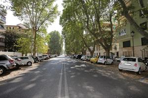 a street with cars parked on the sides of the road at Houspitality Caesar Bed & Breakfast in Rome