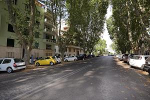 a street with cars parked on the sides of the road at Houspitality Caesar Bed & Breakfast in Rome