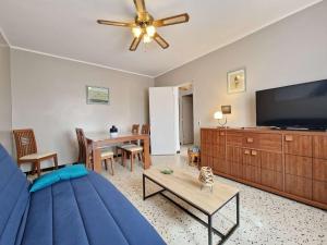 マルセイヤンにあるVilla Marseillan-Plage, 3 pièces, 6 personnes - FR-1-387-62のリビングルーム(青いソファ、薄型テレビ付)