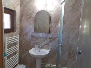 a bathroom with a sink and a mirror at Pensiunea Mery in Albac +17 photos