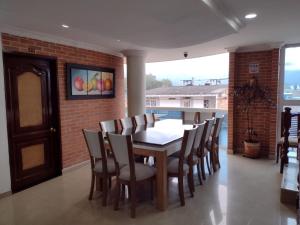 a dining room with a table and chairs at HOTEL NAPOLES in Pitalito