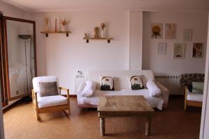 a living room with a couch and two chairs and a table at Chalet en Comillas in Comillas