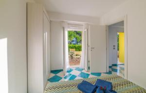 a bedroom with a bed with blue pillows on it at Beautiful Apartment In Deiva Marina in Deiva Marina