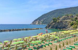 a beach with many chairs and umbrellas on it at Beautiful Apartment In Deiva Marina in Deiva Marina