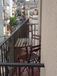 a table and chairs on the balcony of a building at San Jordi Tossa de Mar in Tossa de Mar
