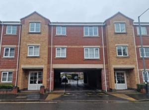 an empty brick building with a garage at Childes Court in Nuneaton