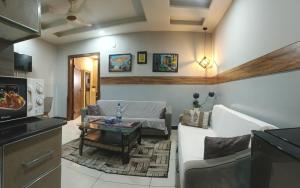 a living room with a couch and a table at Vaporium apartments Bahria RWP in Rawalpindi +17 photos