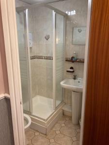 a bathroom with a shower and a sink at Iona Hotel in Blackpool