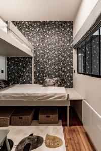 a bedroom with a bed and a wall with flowers at Les Jacobins, hypercentre in Lyon
