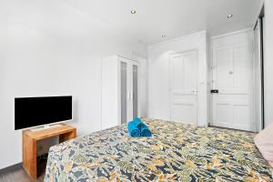a bedroom with a bed and a flat screen tv at Nice Renting - PAGANINI - New Lovely Cosy Flat in Heart of Nice in Nice