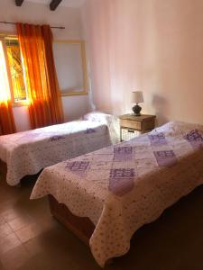 a bedroom with two beds and a window at Casa de Myri in Villa Carlos Paz