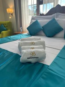 a hotel room with towels on a bed at Benjamine's Guesthouse in La Digue