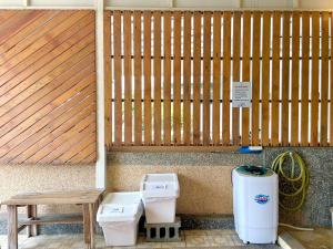 a couple of toilets sitting next to a wooden fence at Loju sunrise inn in Xiaoliuqiu