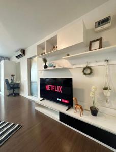 a living room with a flat screen tv on a shelf at "500m from Beach Modern Residence" in Hua Hin