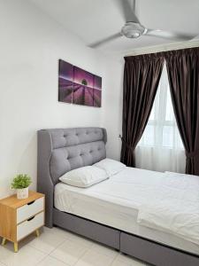 a bedroom with a bed and a night stand and a window at D'CIELLA Homes- Sea View, Drawbridge & KTCC Mall in Kuala Terengganu