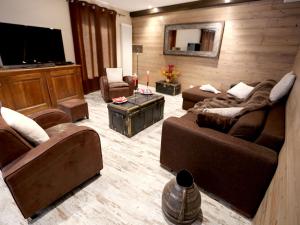 a living room with couches and a flat screen tv at Appartement Valloire, 4 pièces, 9 personnes - FR-1-263-215 in Valloire