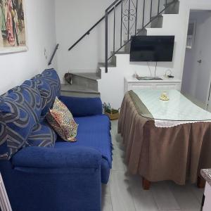 a living room with a blue couch and a table at Casa Rural "La Casita" in Pujerra