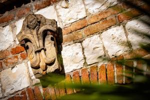 a stone face on a brick wall at Fortino Napoleonico in Ancona