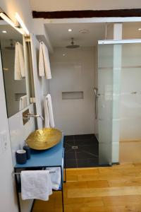 a bathroom with a wooden sink and a shower at Art-be-and-b Appartement -Studios in Riegel am Kaiserstuhl