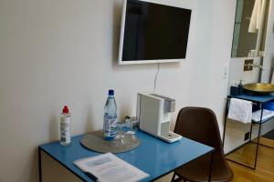 a blue desk with a computer on top of it at Art-be-and-b Appartement -Studios in Riegel am Kaiserstuhl