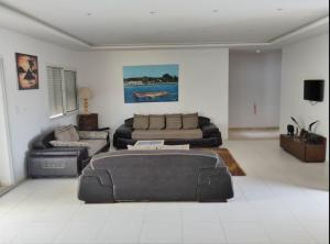 a living room with a couch and a table in it at Maison LIANE familiale au calme in Hammamet