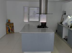 a kitchen with a white counter top in a room at Maison LIANE familiale au calme in Hammamet