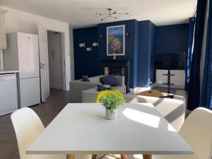uma sala de estar com uma mesa branca e uma parede azul em Town Center Beautiful 2 Bed Apartment em Kinsale