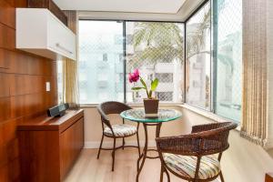 comedor con mesa, sillas y ventana en Conforto em Apartamento no Jurere Open Shopping P1529, en Florianópolis
