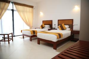 Postel nebo postele na pokoji v ubytování Serenique Resort Kandy + 37 fotografií