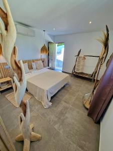 a bedroom with a bed and some birds on the floor at Villa Lomy Casares in Casares
