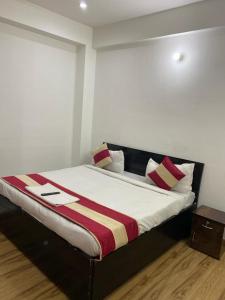 a bed in a room with red and white pillows at Hotel Star Corporate Suite 586 in Gurgaon