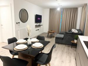 a living room with a black table and chairs at 2 bedroom Apartment in Manchester