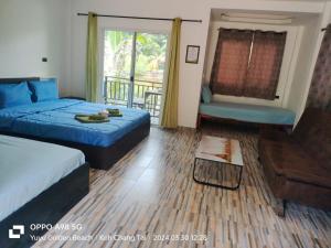 a bedroom with a bed and a couch and a balcony at Yuyu Golden Beach in Ko Chang