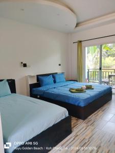a bedroom with two beds and a balcony at Yuyu Golden Beach in Ko Chang