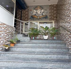 a set of stairs in front of a building with plants at PN SAMY INN in Puducherry