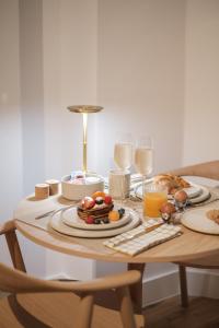 a table topped with plates of food and glasses of milk at B&B The Four in Mechelen