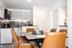 a kitchen with a dining room table and chairs at Villa Stone - Pool house 100 meters from the beach in Vinišće