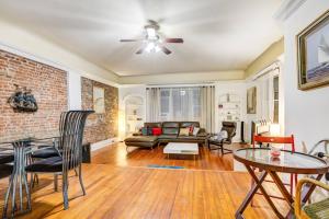 a living room with a ceiling fan and a brick wall at 3BR Skyline Apt in Bustling District I Great Value in West New York