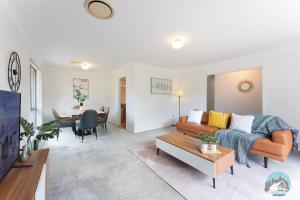 a living room with a couch and a table at Aircabin - Marayong - Convenient - 3 Beds House in Blacktown