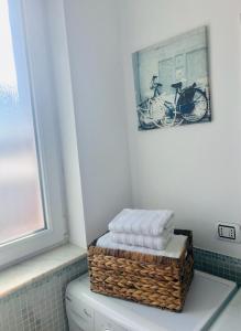 a basket sitting on top of a toilet in a bathroom at Fortress View in Râşnov