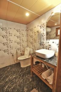 a bathroom with a sink and a toilet at Dyar Koul in Shimla +23 photos