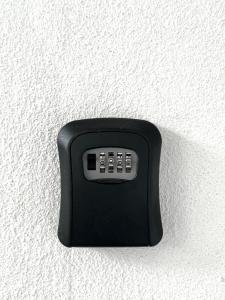 a black remote control attached to a wall at Kicauan RoomStay #1 Kuala Berang-Free WiFi & Netflix for 2 Pax in Kuala Berang