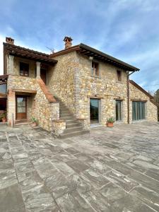 a stone house with a stone driveway in front of it at Villa Castagnone in Agna