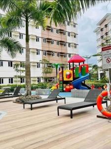 a park with a playground with a slide at Cozy Belle Suite Relaxing Place at SMDC Hope Residences in Trece Martires