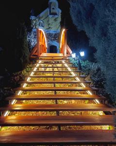 a set of stairs in front of a house at night at Hotel Szent István in Eger +41 photos
