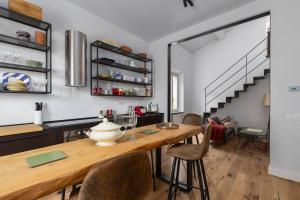 a kitchen and dining room with a wooden table and chairs at Dimora San Donato in Casole dʼElsa