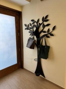 a wall with a plant with bags on it at Casa Brasile in Vico Equense