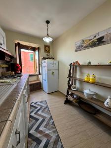 a kitchen with a white refrigerator in a room at Casa Brasile in Vico Equense