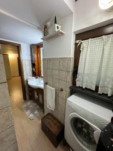 a bathroom with a washing machine and a sink at Casa Brasile in Vico Equense