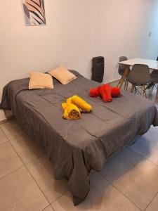 een bed met drie kussens erop bij DPTO UN DORMITORIO C/COCHERA- CENTRO VILLA MARIA in Villa María